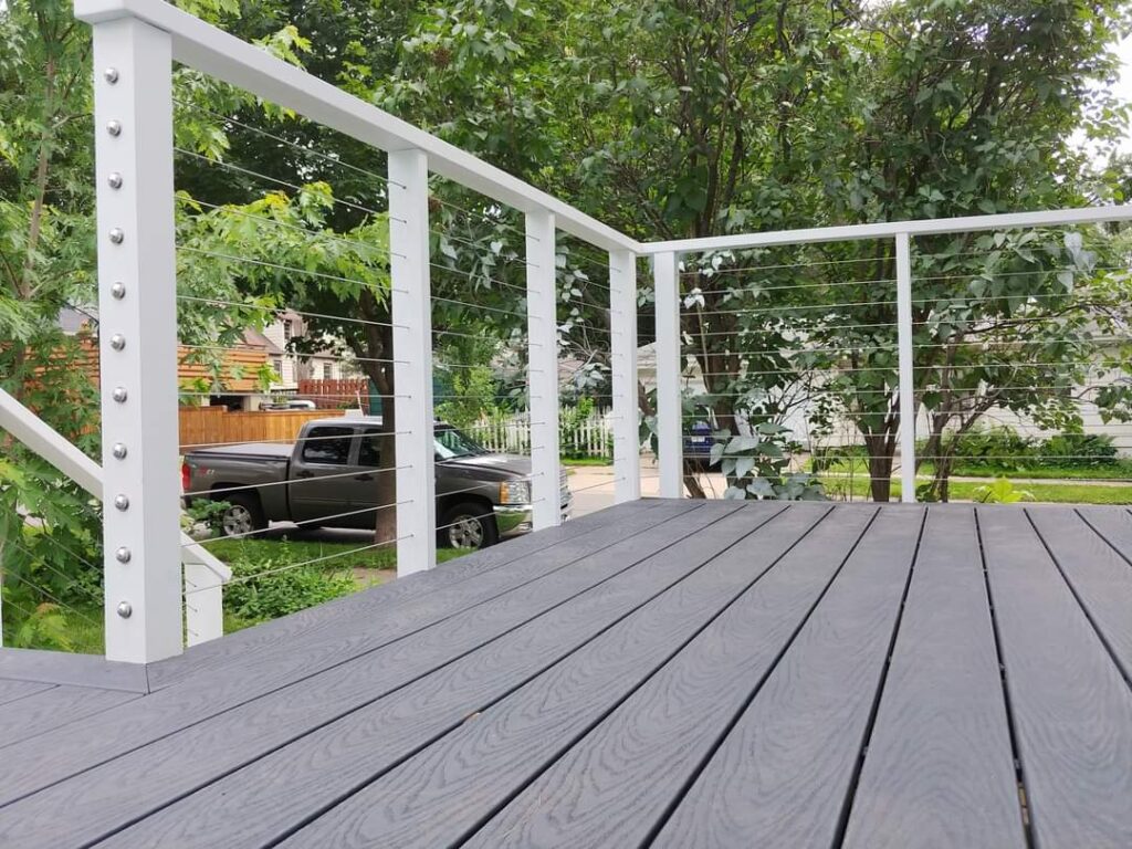 A deck with a view of the back yard.