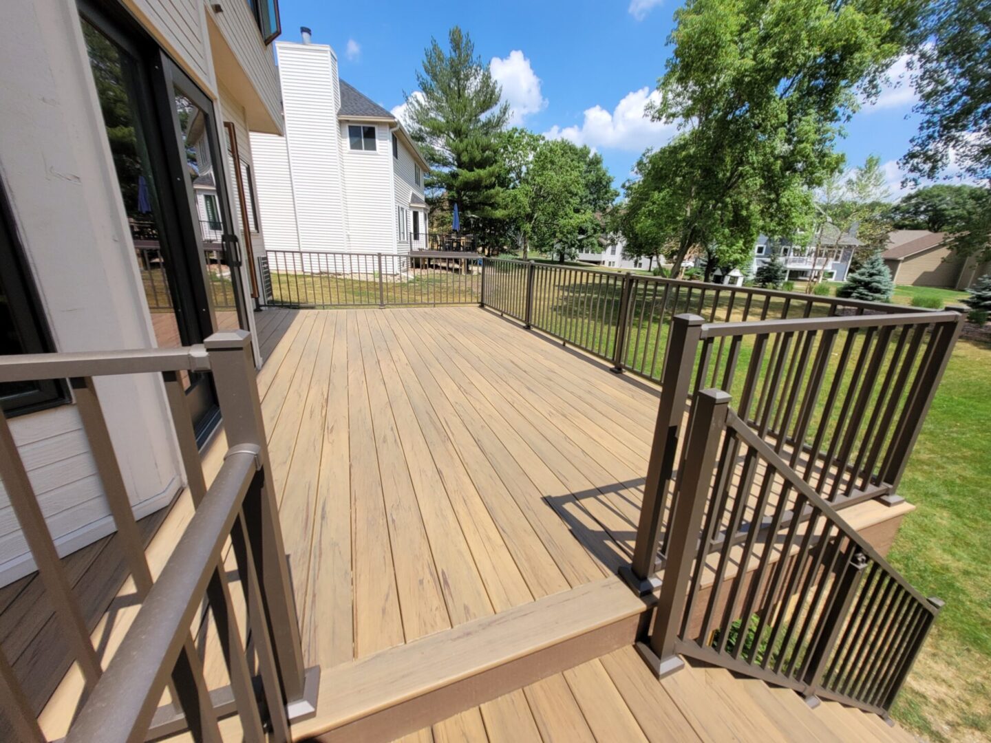 light deck brown railing backyard view scaled