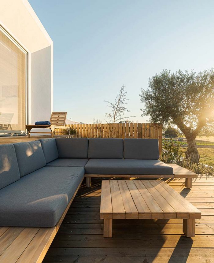 A wooden deck with a couch and table