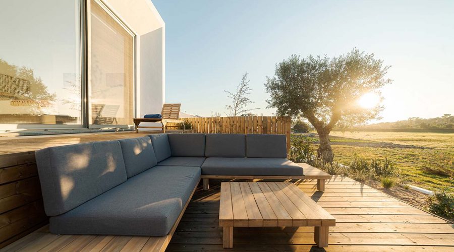 A wooden deck with a couch and table