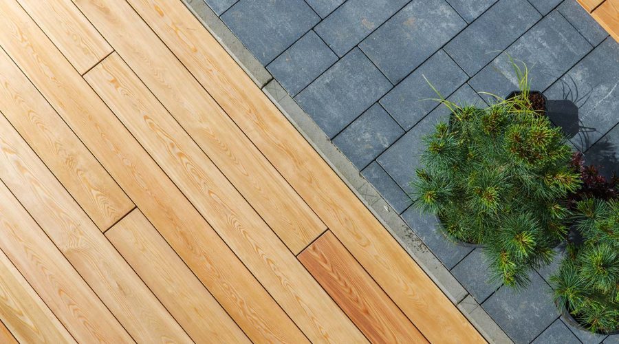 A close up of the wood and tile floor