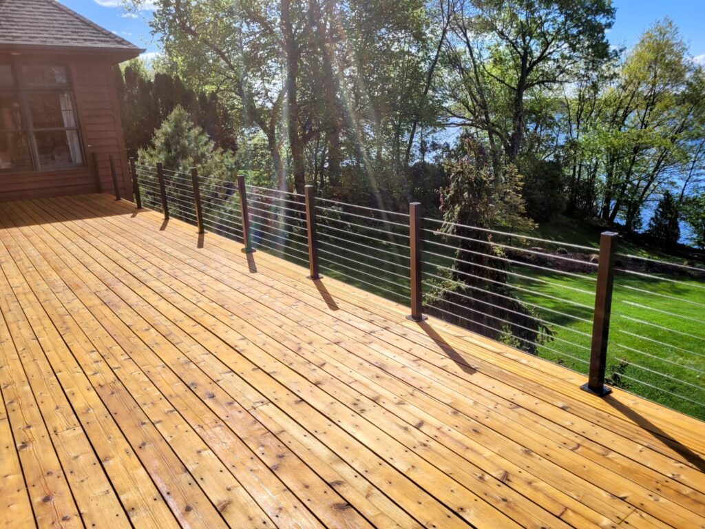 Wood deck, black railing, backyard lake view