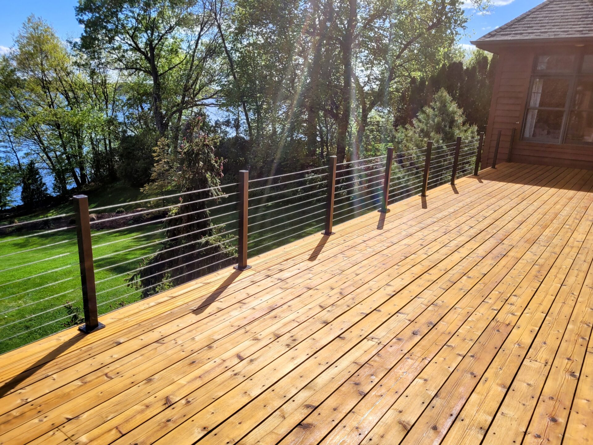 wood deck, black railing, green backyard