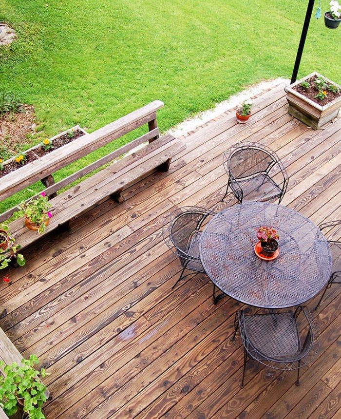 A wooden deck with a table and chairs