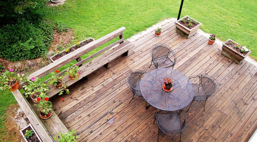 A wooden deck with a table and chairs