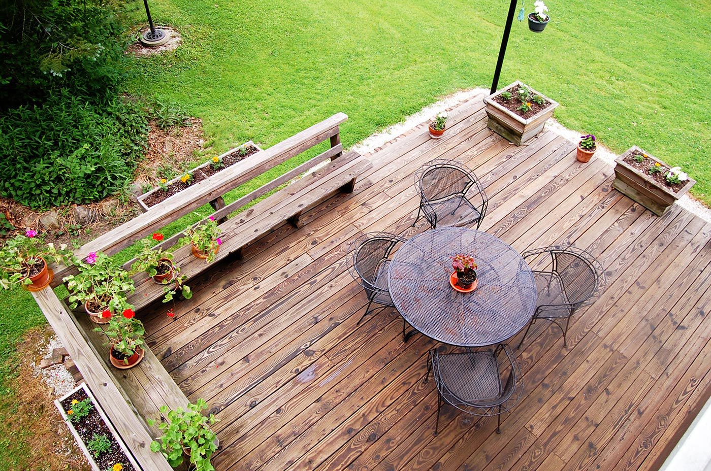 A wooden deck with a table and chairs