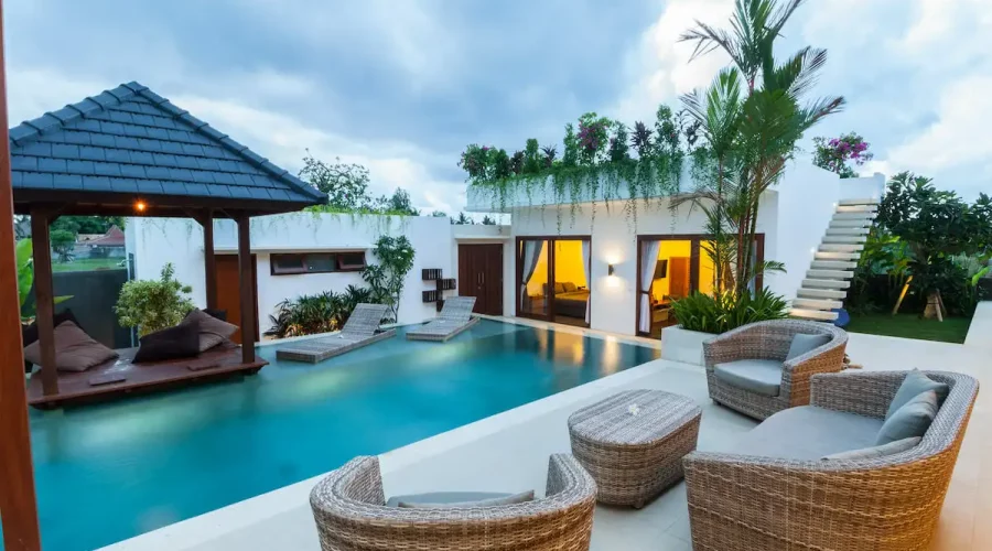 A pool with chairs and tables in it