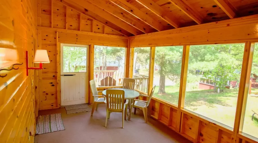 A room with wood paneling and a table in the center.