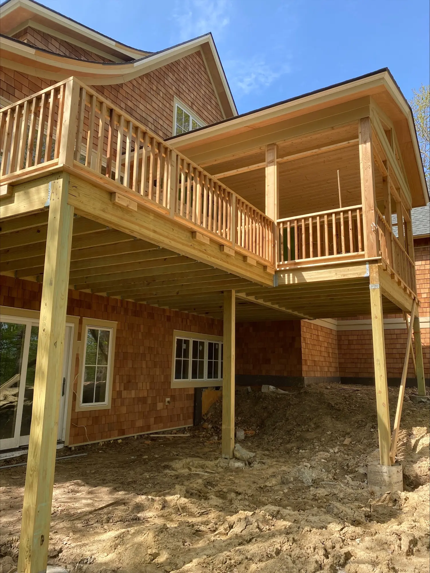 A house with a deck and stairs going up the side.