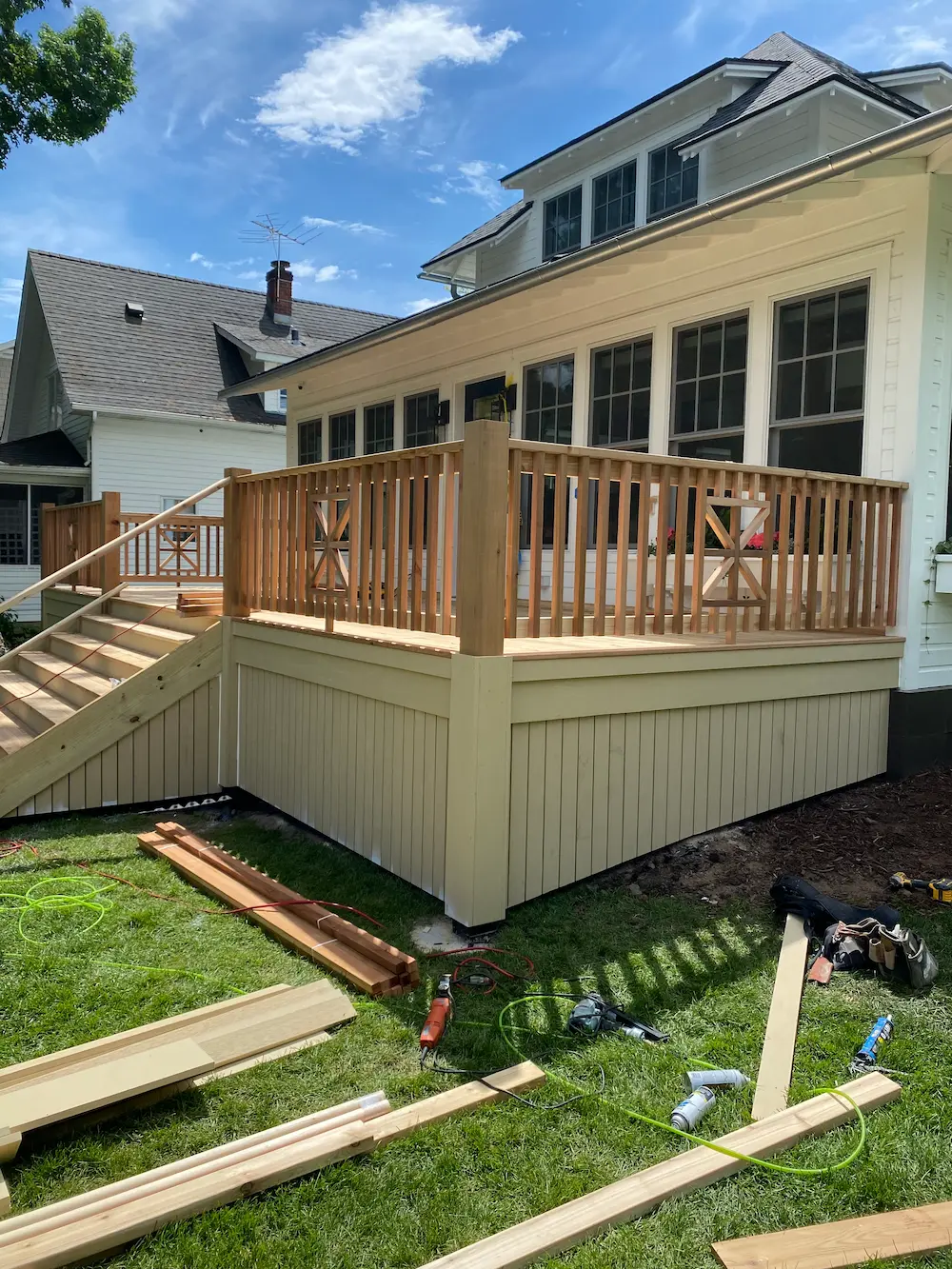 A deck being built in the yard of a house.