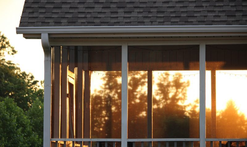 A window with the sun setting behind it.