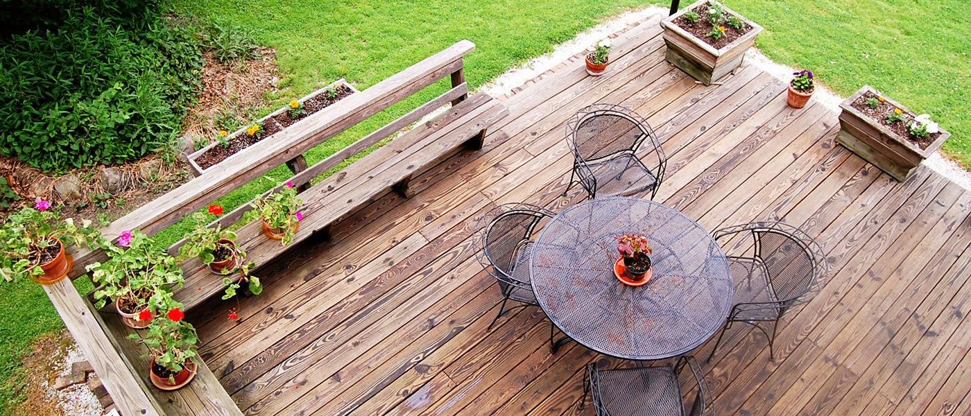 A wooden deck with a table and chairs