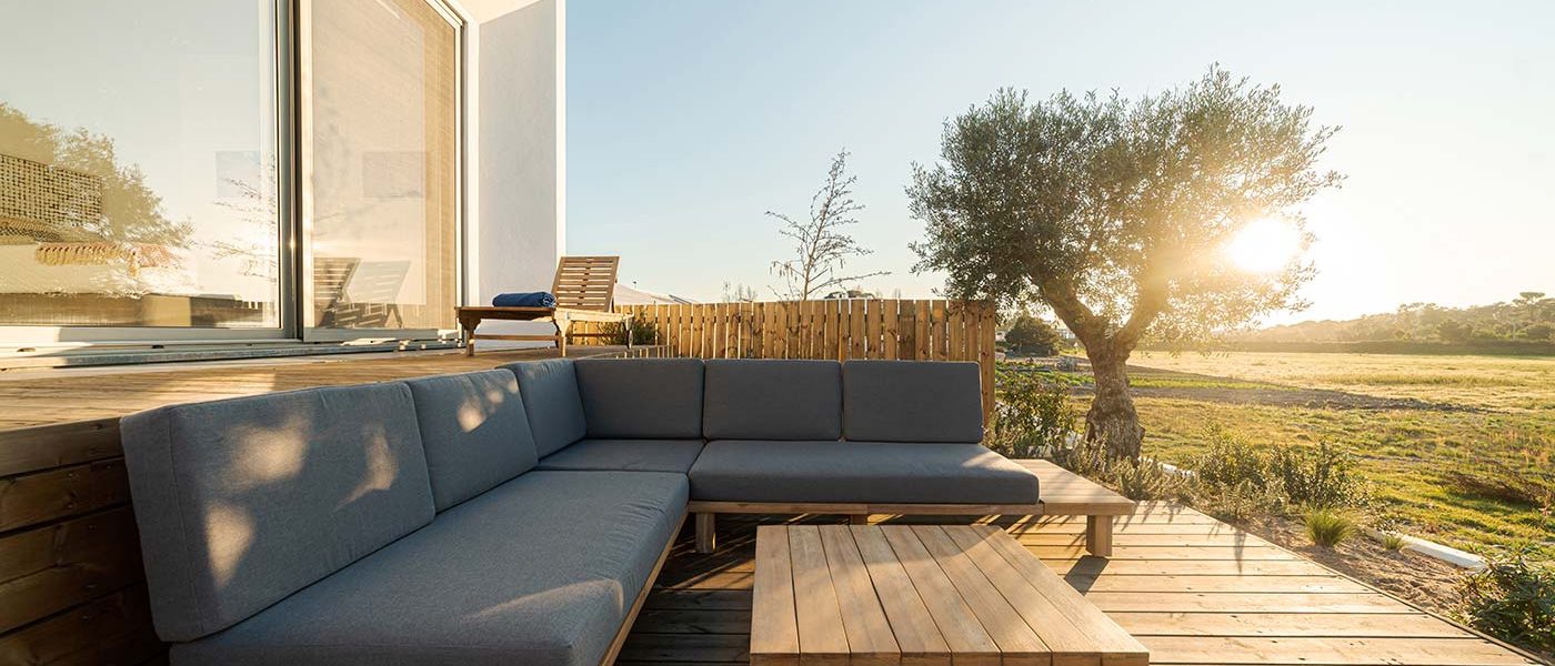 A wooden deck with a couch and table