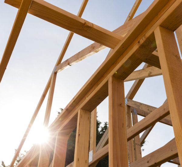 A building under construction with the sun shining.